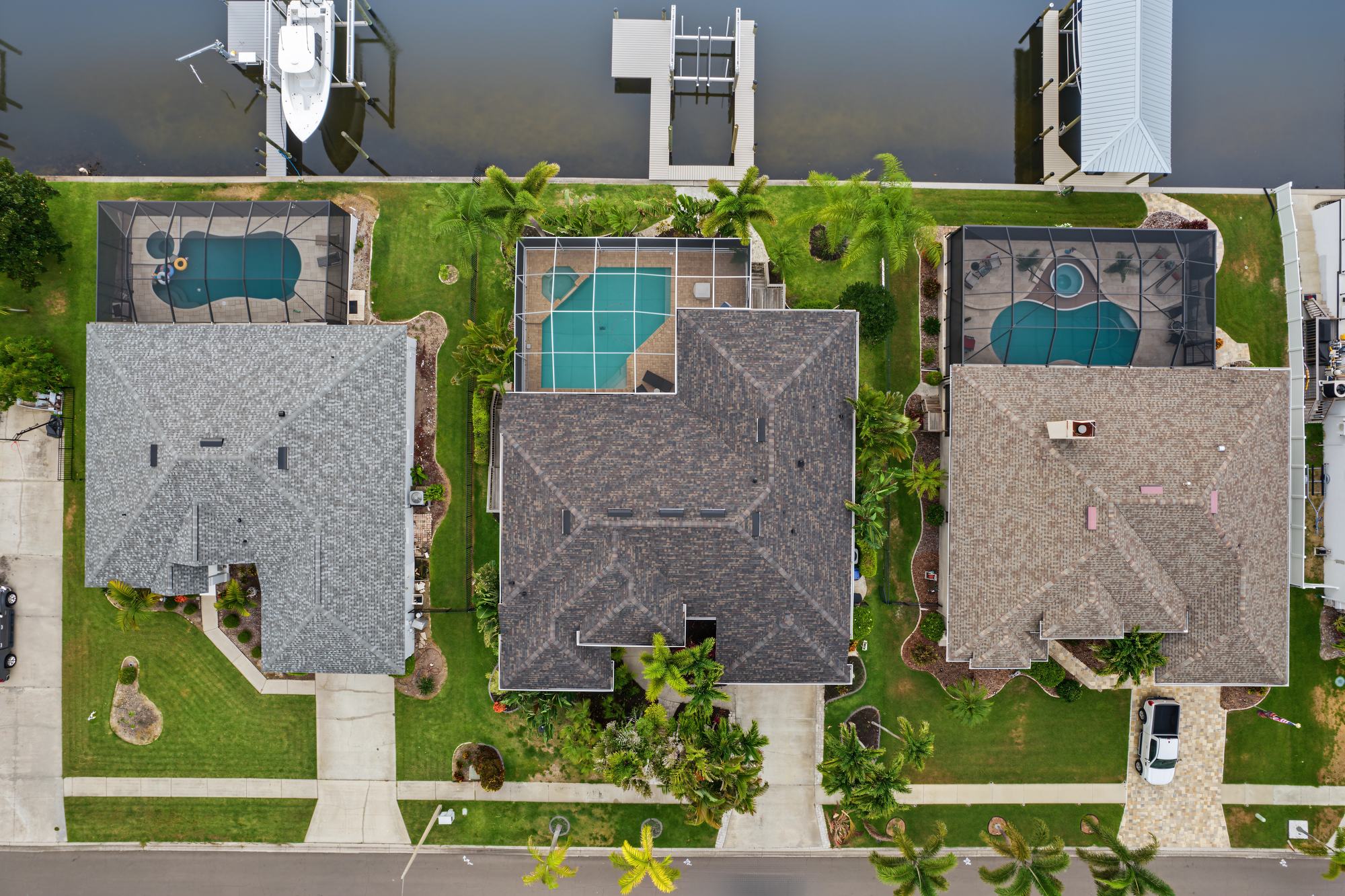 Top-down drone photo of homes with backyard pools