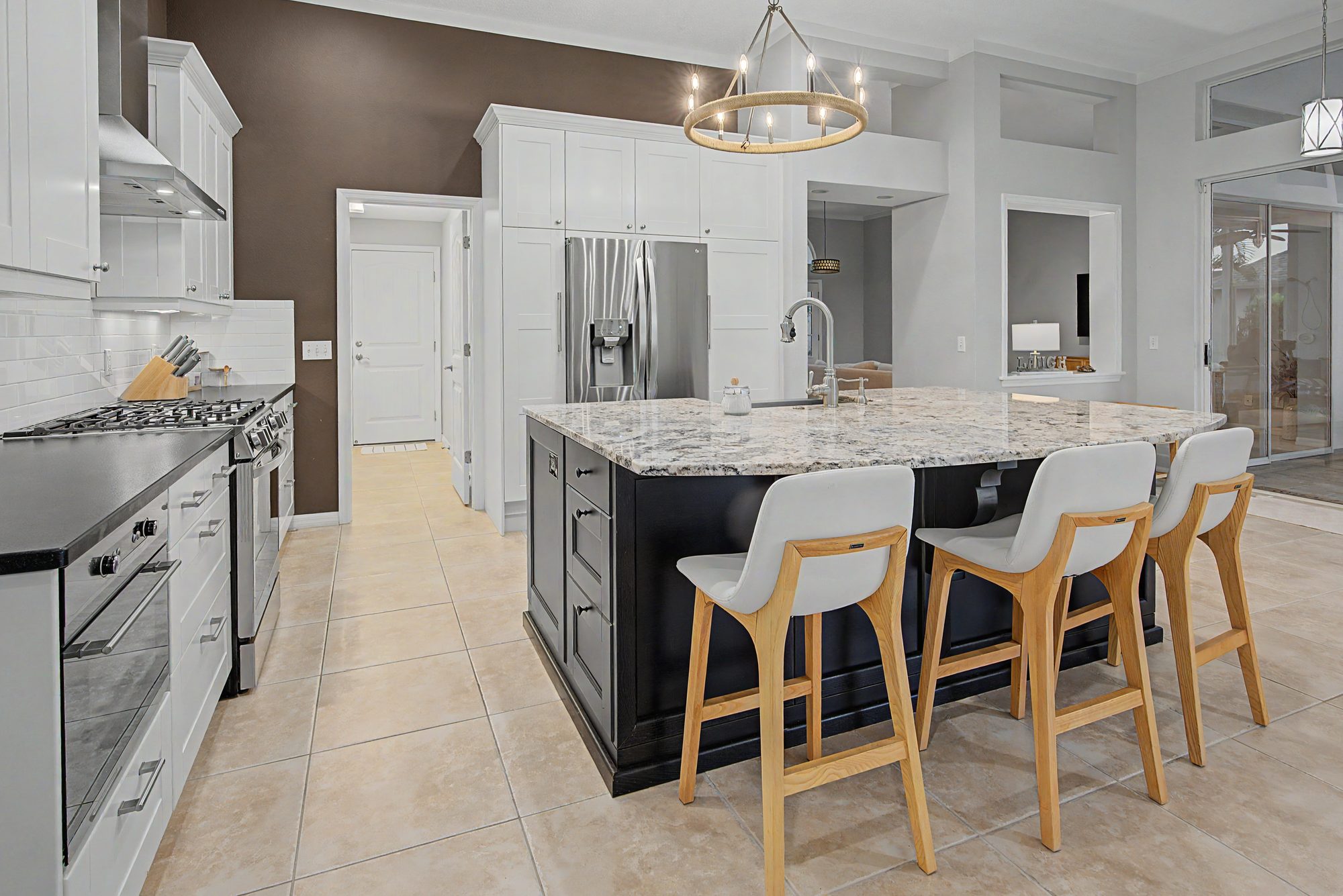 Modern kitchen with a dark island and bar stools